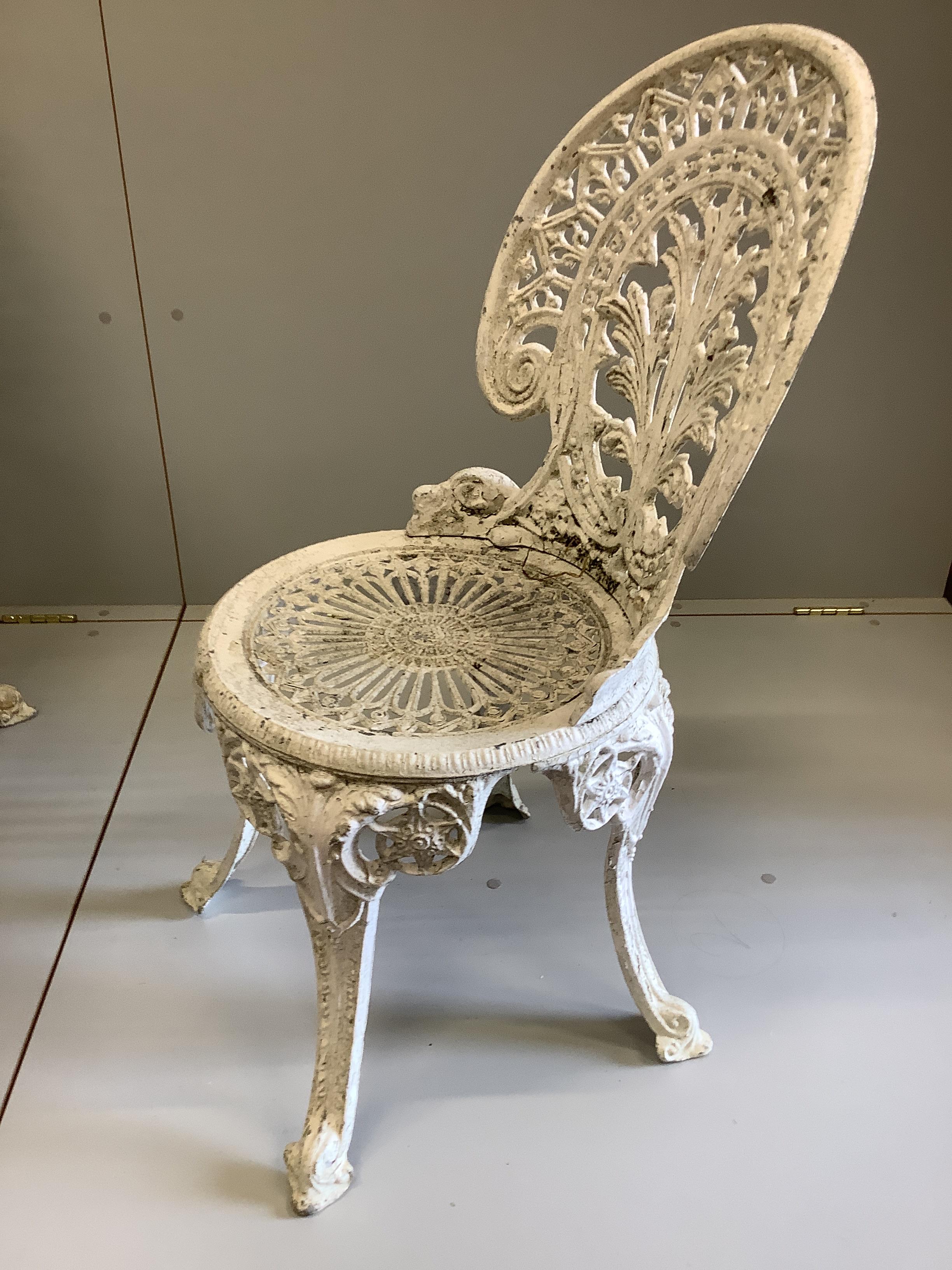 A Victorian style painted cast aluminium circular garden table, diameter 106cm, height 70cm, together with four matching chairs (table, one leg a.f.)